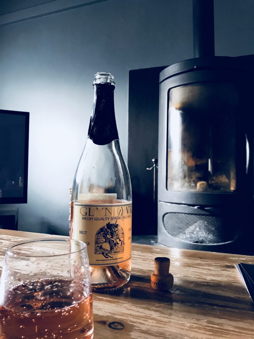 Welsh sparkling wine with log burner at The Corran Resort