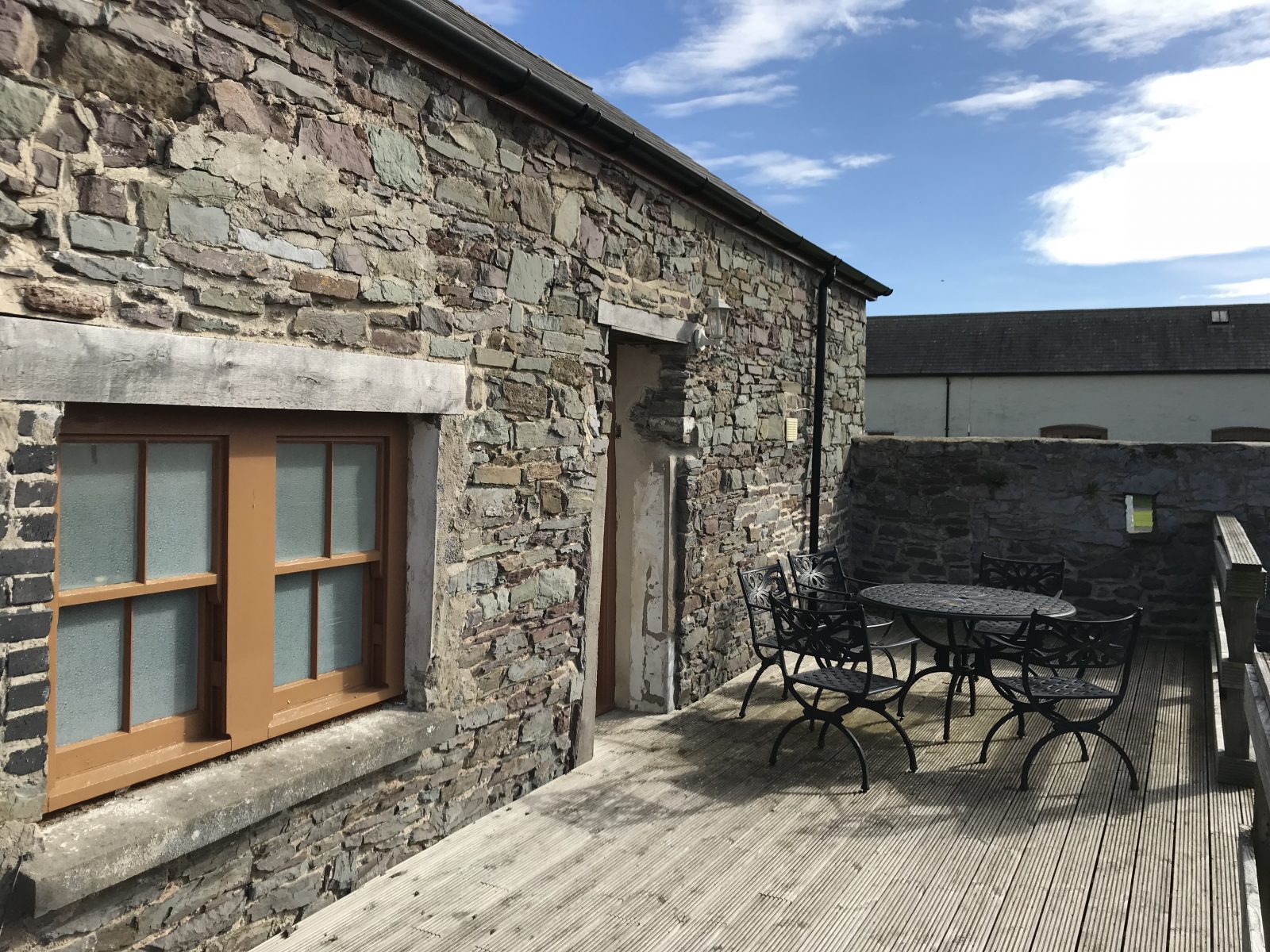Terrace seating outside cottage at The Corran Resort